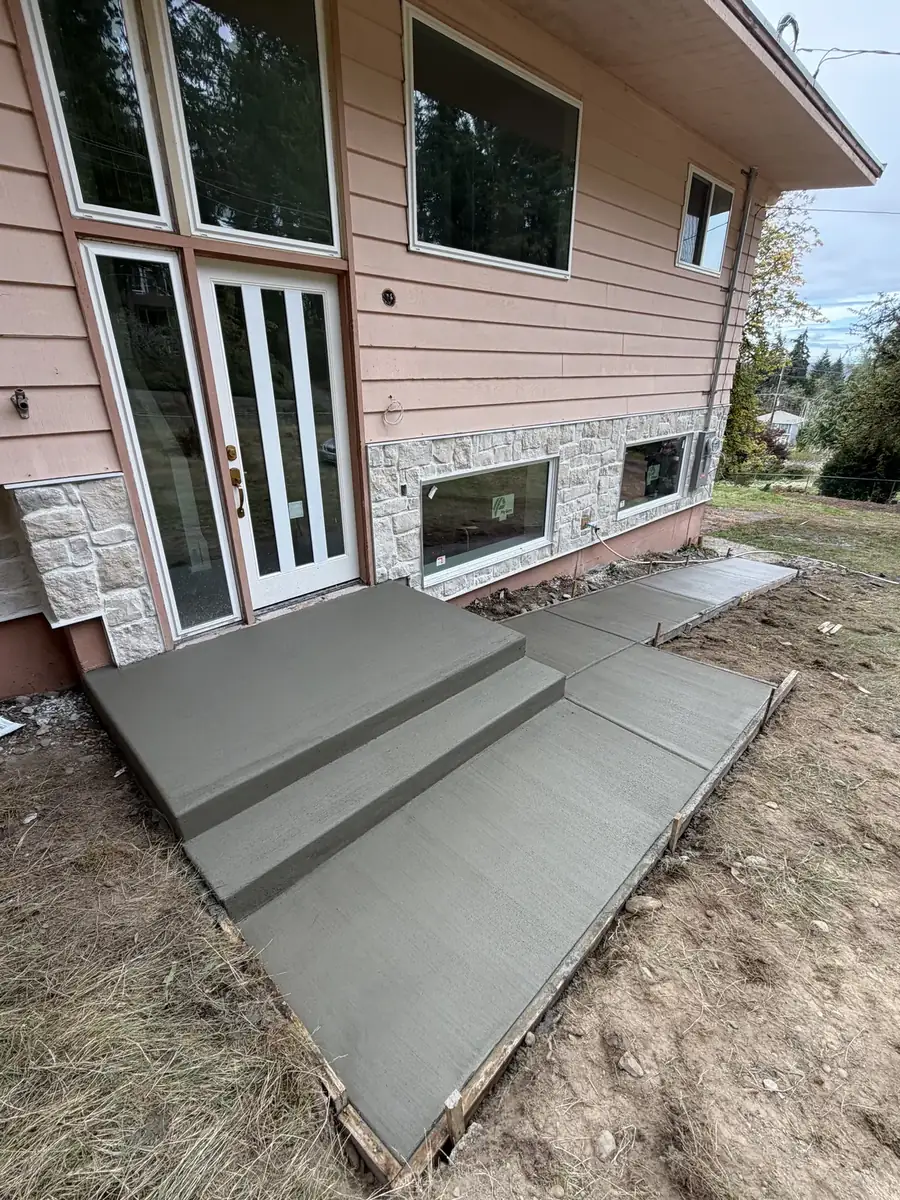 New concrete patio landing with wide steps at a home near Olympia, WA