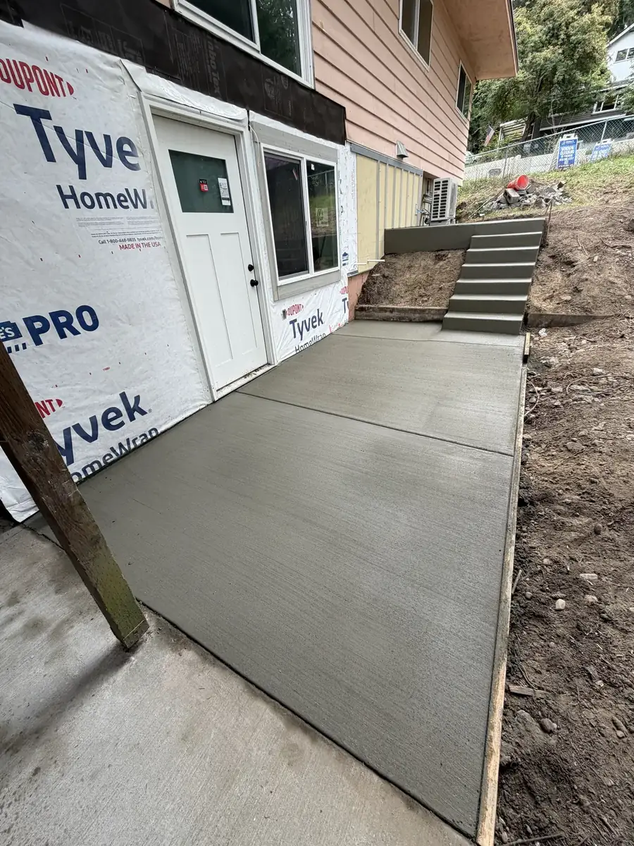 New concrete patio and walkway along the back of a house near Olympia, WA