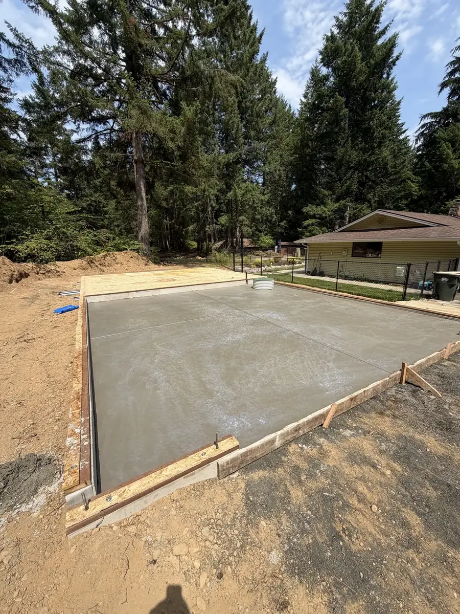 Large poured concrete shop pad surrounded by trees in Thurston County, WA