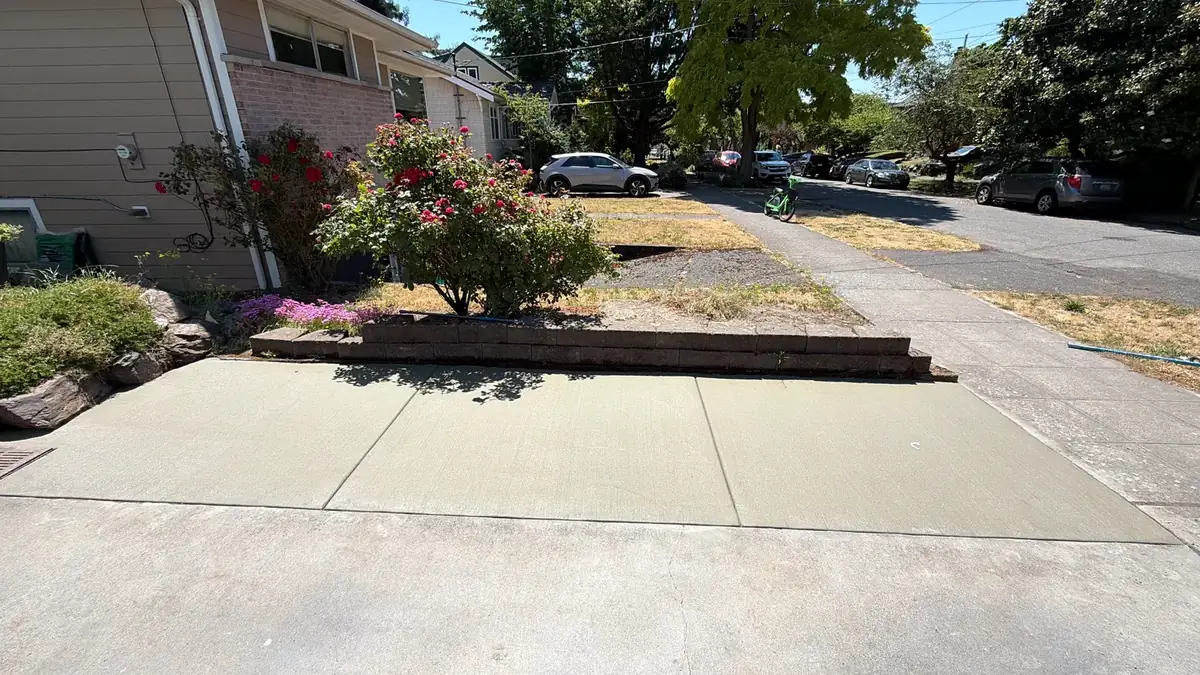 New concrete sidewalk and driveway apron along a residential street in Olympia, WA