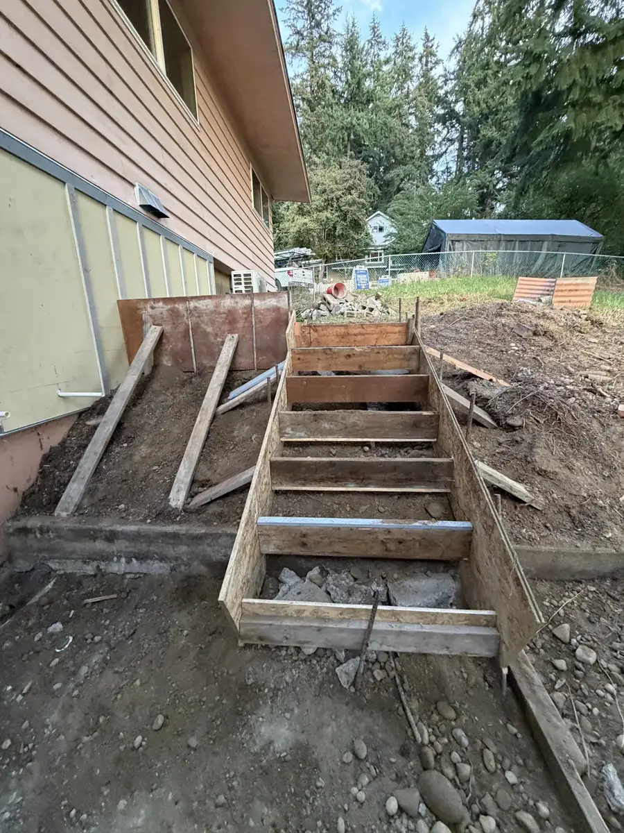 Wood stair forms set against a house for new concrete steps near Olympia, WA