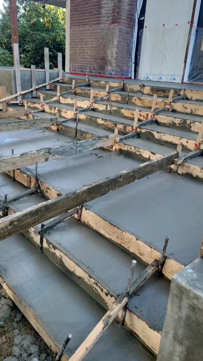 Concrete steps being poured inside wood stair forms near Olympia, WA