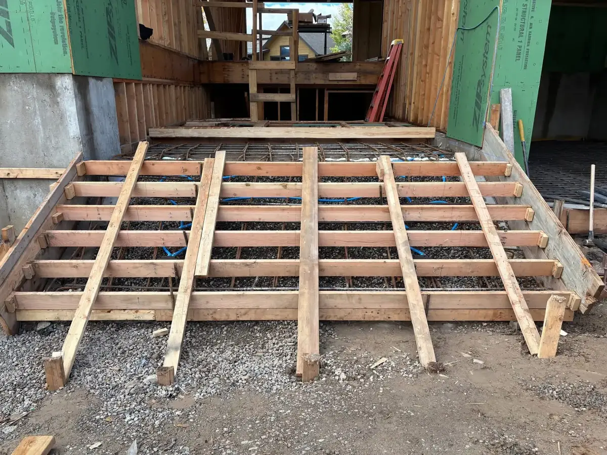 Wood forms and rebar set for a concrete slab inside a framed structure near Olympia, WA