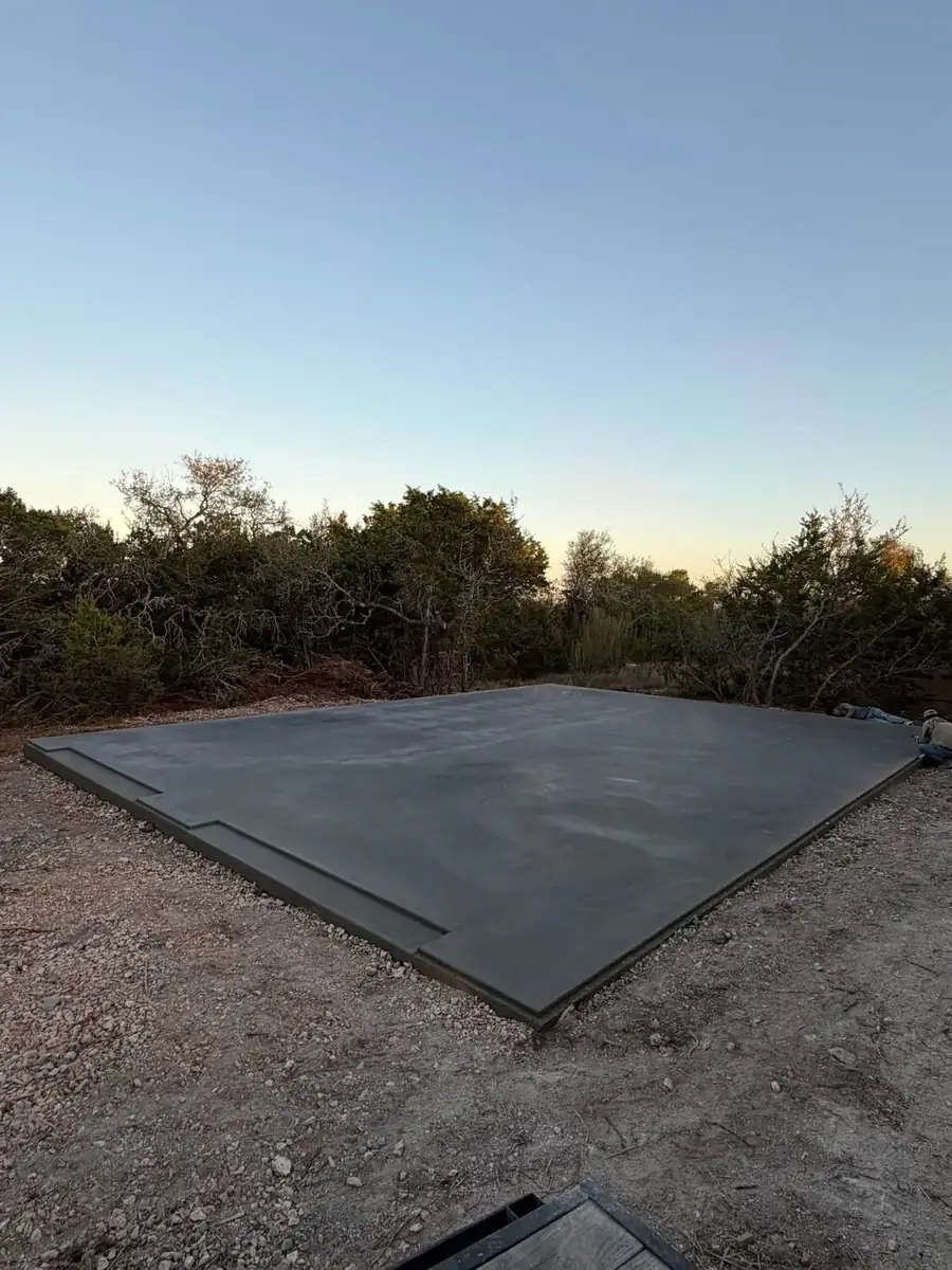 Finished concrete pad on a cleared lot at sunset in Thurston County, WA
