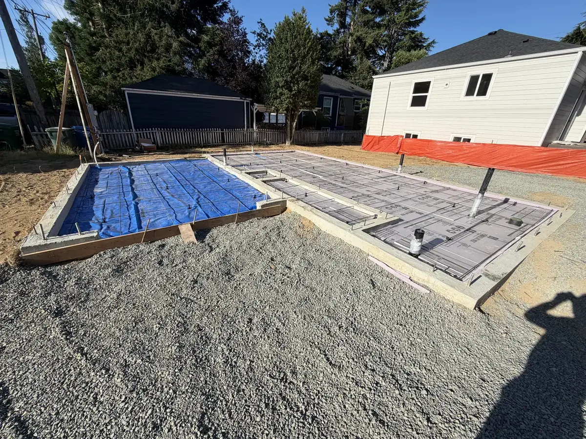Foundation slab forms with rebar over a compacted gravel base near Olympia, WA